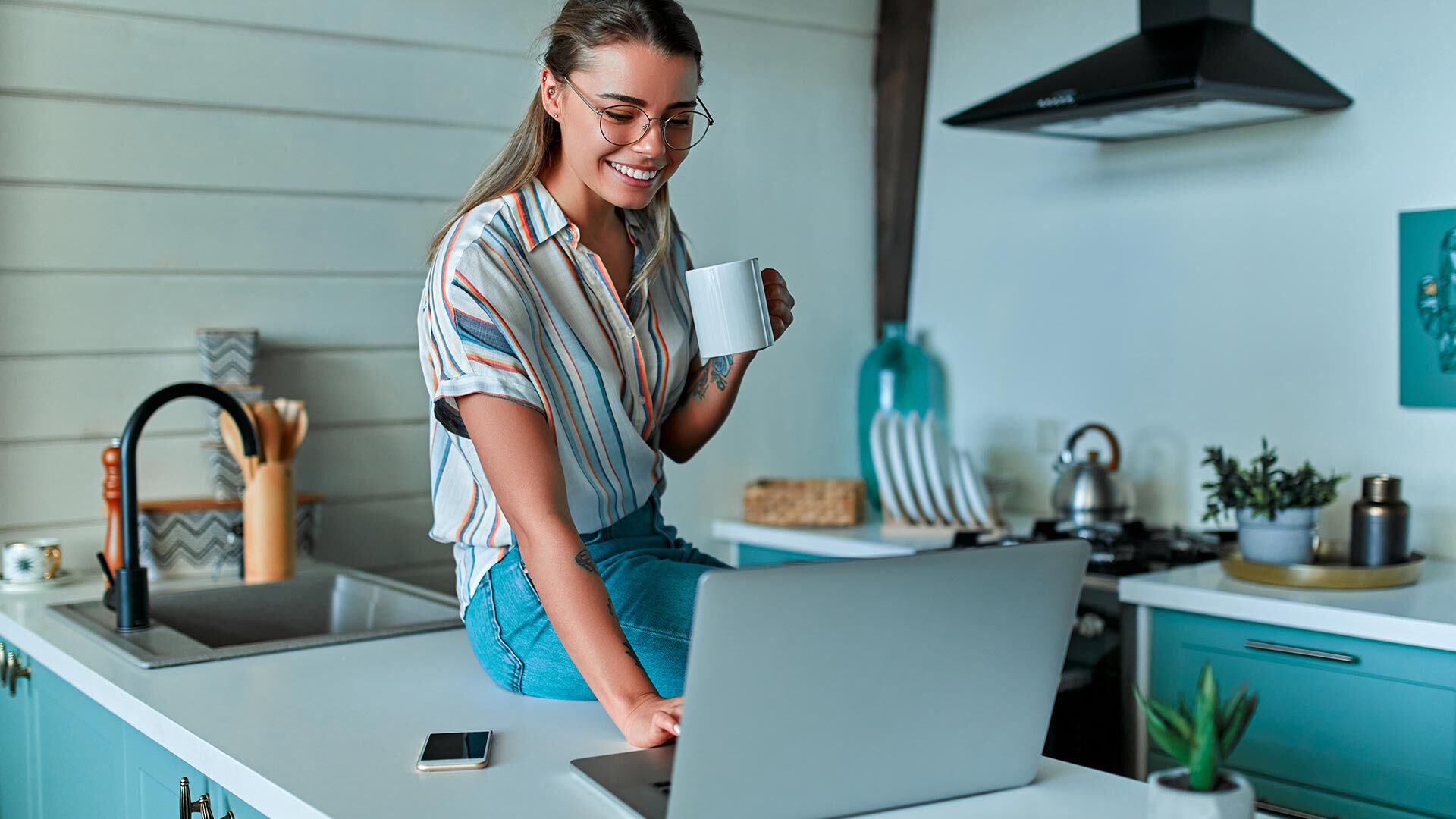 woman shopping on computer and drinking coffee